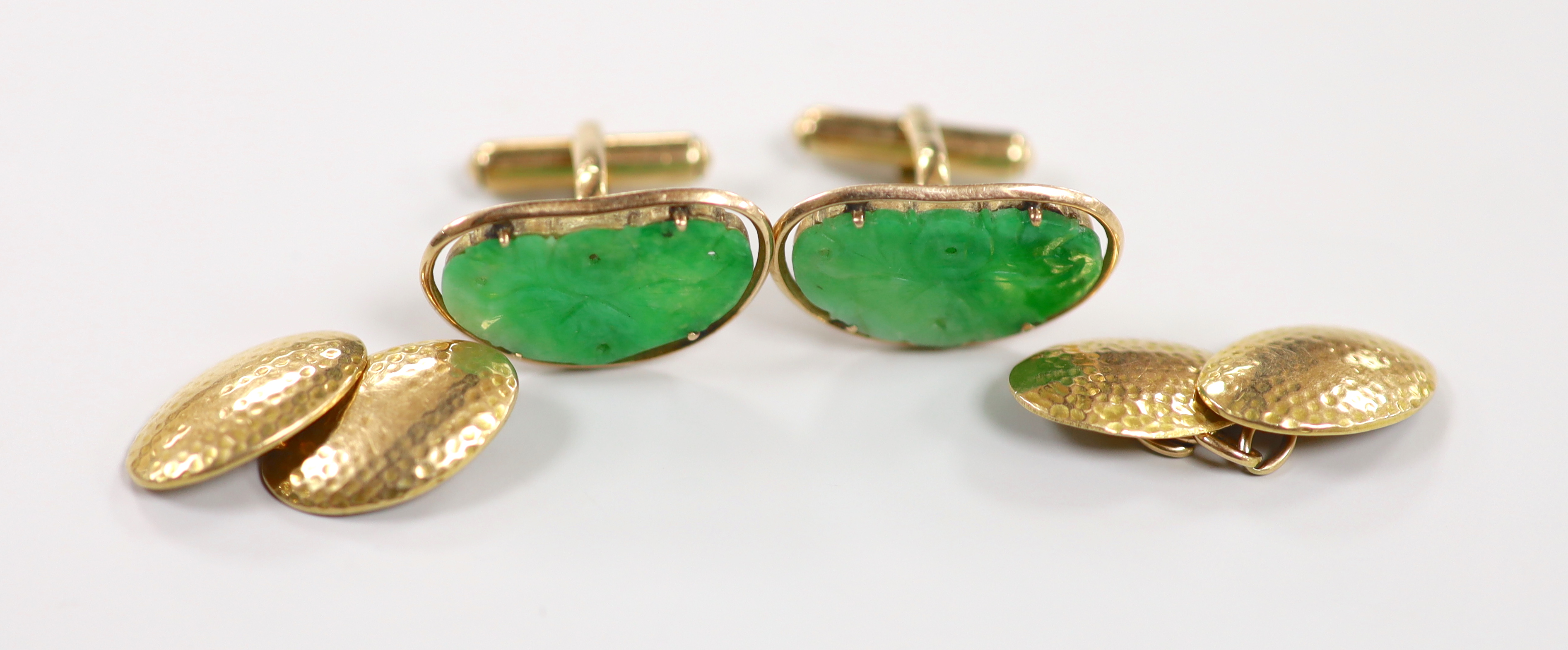 A pair of Chinese yellow metal mounted carved green jade cufflinks, 23mm, together with a further pair of planished yellow metal cufflinks, gross weight 15.3 grams.